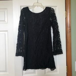Black lace overlay, lined dress with scooped back.  Sheer lace sleeves.